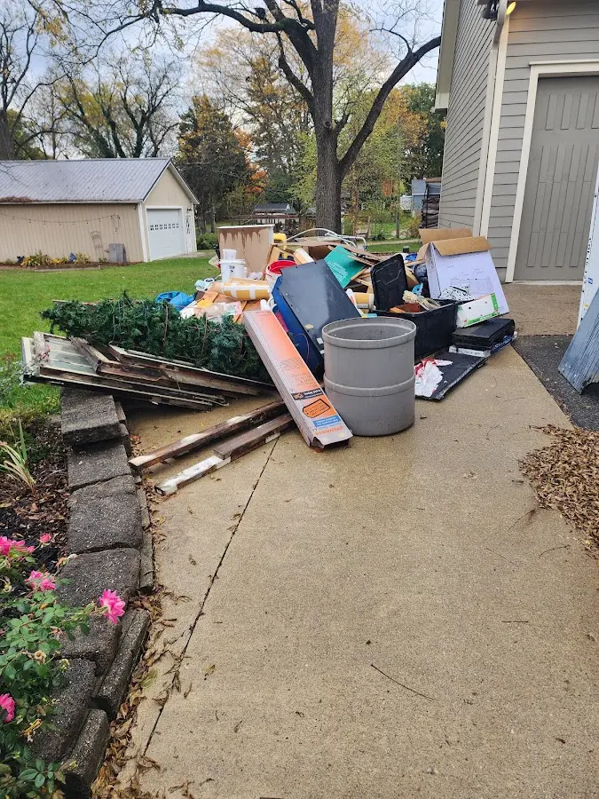 Dumpster being loaded with debris for Residential Dumpster Rental in Heartland